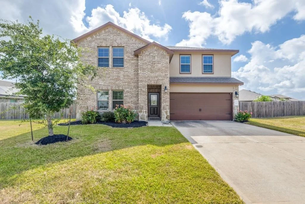 Single story home in Sienna, Missouri City TX with covered patio and two-car garage